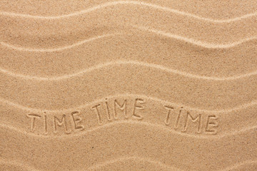 Time inscription on the wavy sand