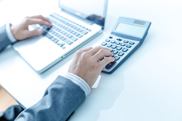 Closeup of businessman hands typing on laptop computer
