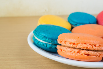 French macaroons on plate, with vintage pastel filtered