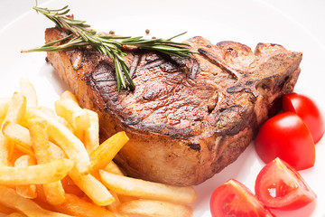Grilled meat with vegetables and french fries
