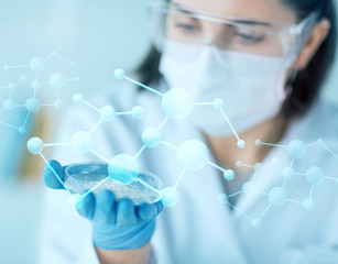 close up of scientist holding petri dish in lab