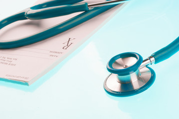Empty medical prescription with a stethoscope on blue background