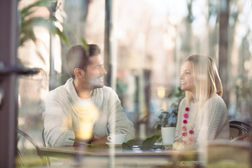 Cheerful young couple on a romantic date in a cafe