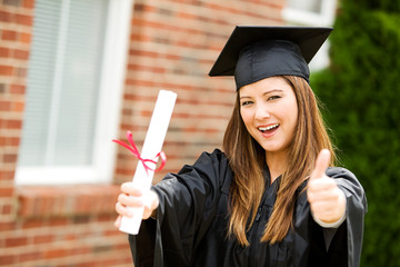 Graduate: Female Student Gives Graduation Thumbs Up