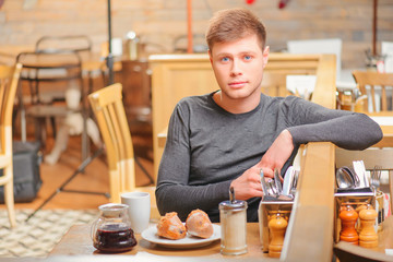 Handsome young man in cafe