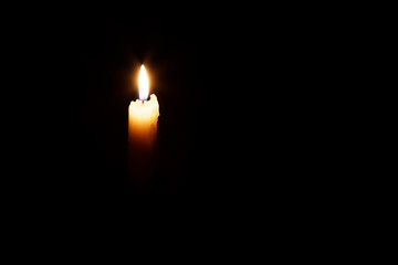 Glowing candle in the dark