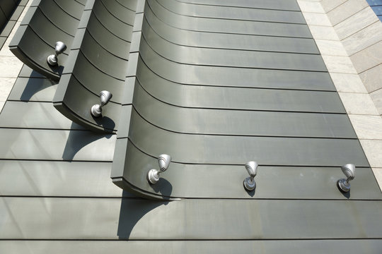 Halogen metal reflectors on modern building grey wall