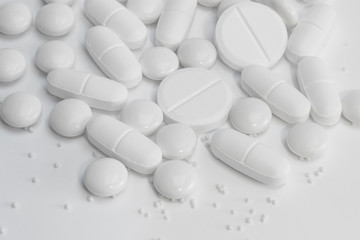 White pills / tablets / medicine close up on white background