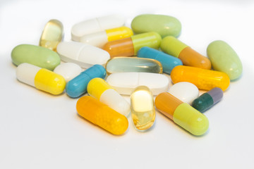 Medicine - many colored pills / tablets - white background
