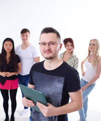 young man in glasses with a book on the background of the group