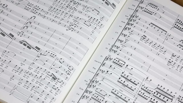 Sheet music with conductor's baton
