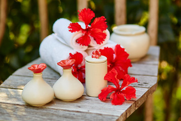 Spa setting with towels and red flowers