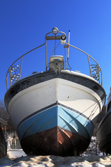 yacht in the winter on the pier on the background of blue sky