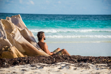Young Male Meditating besides Caribbean Sea. At Tulum, Mexico.
