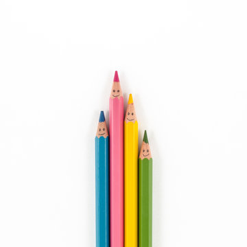 Color pencils with smile faces isolated on white