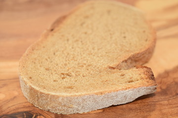 A slice of bread on a chopping board.