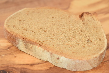 A slice of bread on a chopping board.