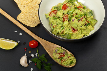 Guacamole on black background. Selective focus.