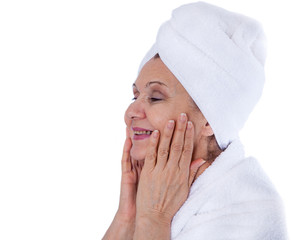 Spa concept portrait. Aged good looking woman with white towel