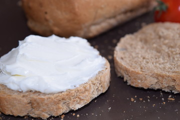 Slice of bread with cream cheese.