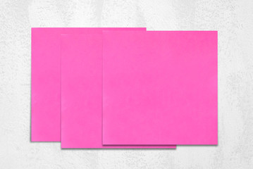 Blank sticky note papers on white cement wall background