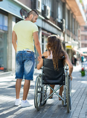 Social worker taking invalid for a walk