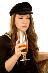 Female holding wine glass wearing black hat and dress