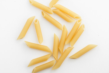 uncooked penne isolated on white background