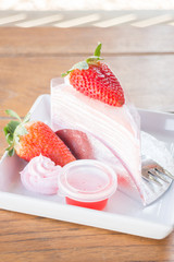 Serving fresh strawberry crepe cake
