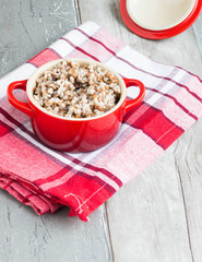 Buckwheat in a pot on the wooden table