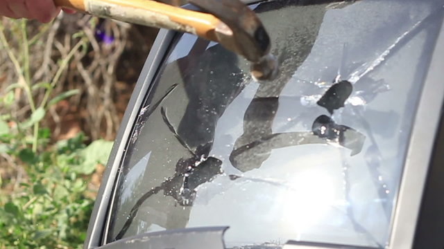 Smashing TV screen with hammer