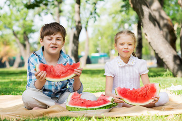 Kids eating watermelon