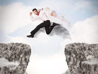 Funny business man jumping over rocks with gap