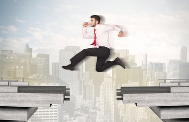 Energetic business man jumping over a bridge with gap