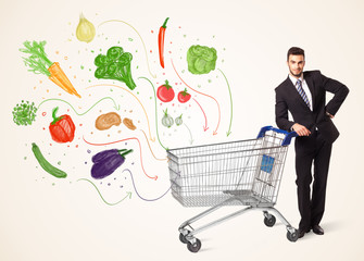 Businessman with shopping cart with vegetables