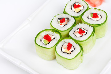 Sushi roll with avocado, cucumber and caviar.