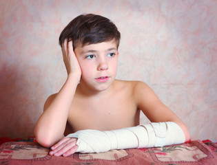 handsome preteen boy with hand in bandage