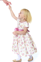 Cheerful little girl holding her mother's finger.