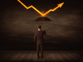 Businessman standing with umbrella keeping orange arrow