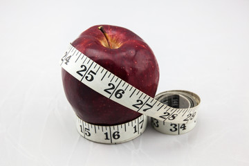 Red Apple with Measure Tape on Isolated White Background
