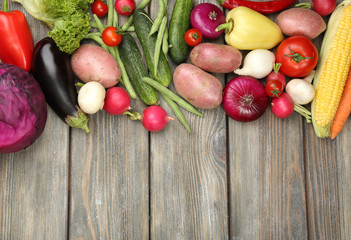 Summer frame with fresh organic vegetables on wooden background