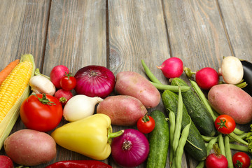 Summer frame with fresh organic vegetables on wooden background