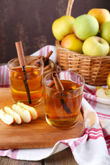 still life with apple cider and fresh apples on wooden table