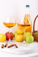 still life with apple cider and fresh apples on wooden table
