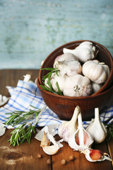 Raw garlic and spices on wooden table