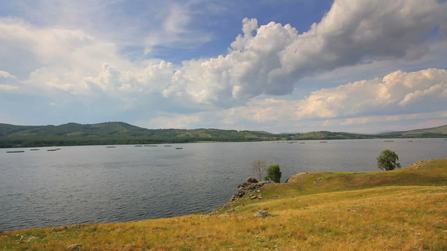 Beautiful timelapse landscape with lake between hills - South ur