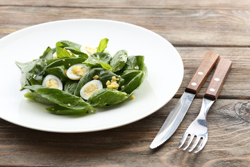 Salad with quail egg and basil in plate