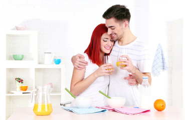 Obraz na płótnie Canvas Happy couple has breakfast in kitchen