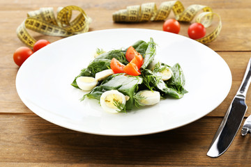 Salad with quail egg and basil in plate
