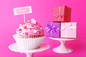 Delicious cupcake with inscription on pink background